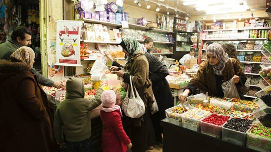 People buying candy in the small streets of Old Jerusalem, Israel