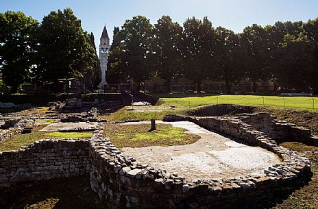 Archaeological area of Aquileia and in background the Basillica's bell tower, Italy