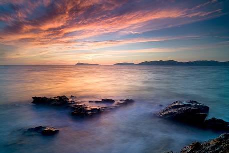 The sunset and emerging rocks give us astonished spectators unrepeatable moments of light along the coasts of Sardinia South West, Teulada, Sulcis-Iglesiente, Italy