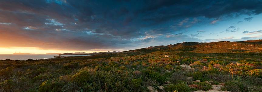 A panoramic image taking over the country immediately in front of the south west coast of Sardinia. In the background Capo Teulada