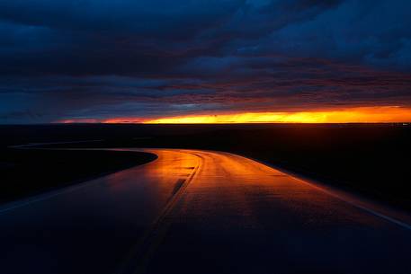 Terrifying sunset reflected on the road, Badlands National Park, South Dakota