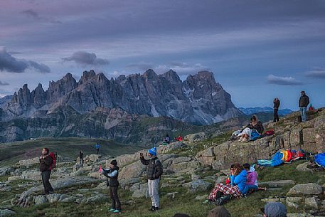 Sounds of the Dolomites, the high altitude music festival in Trentino.  At Sunrise many people listen to a concert on Col Margherita with Pale di San Martino Dolomites in background, dolomites, Italy