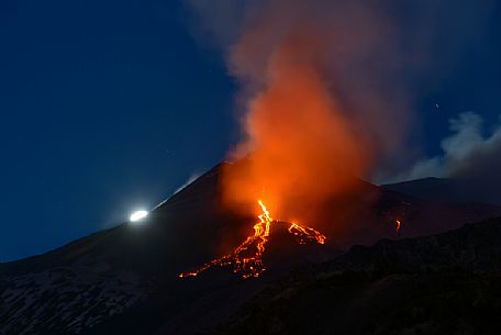 Etna and the moon in a nighttime eruption, Etna mount, Sicily, Italy, Europe