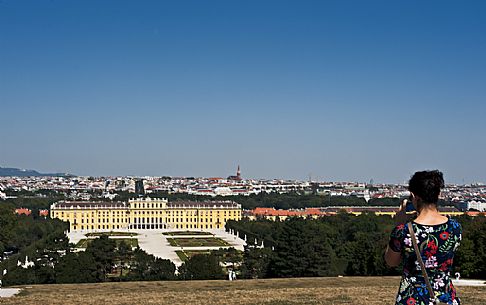 A girl photographs the Schnbrunn Palace in Vienna. It is an imperial summer residence and  a baroque palace, one of the most important architectural, cultural, and historical monuments in Austria.