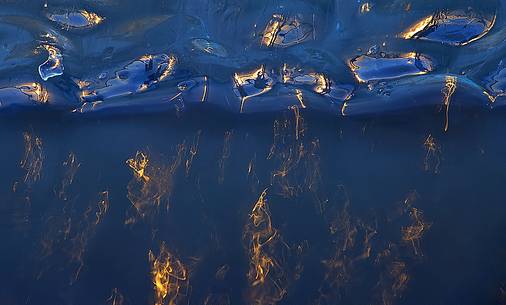 A texture of the ice lightened by the warm light of the sunrise creates sparkles