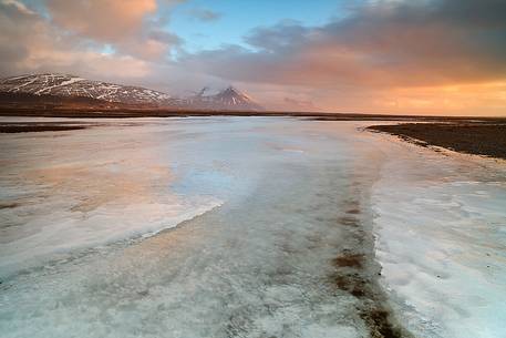 A frozen land at sunrise time