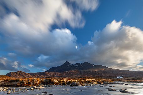 The late afternoon light embraces the landscape and a little cottage at sligachan, admiring the Cuillins on the background