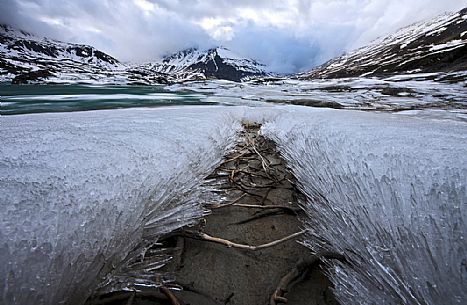 Ice formations in melting on the bottom of the lake of Mont Cenis dam