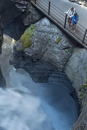 Tourists at the Trummelbach waterfalls formed by melting waters of Jungfrau glacier, Lauterbrunnen valley, Switzerland, Europe