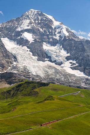 Typical swiss red train on Kleine Scheidegg, Jungfraujoch Railway, mountain pass between Eiger and Lauberhorn peaks, Grindelwald, Switzerland, Europe