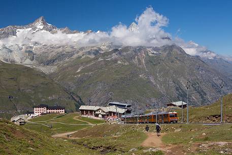 Train of Gornergrat railway at Riffelalp, in  the background  the mountain range over Zermatt village, Valais, Switzerland, Europe