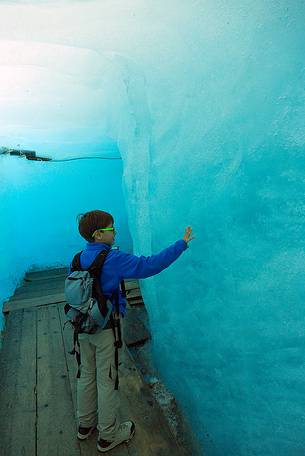 Child inside the Rhone glacier, Furka pass, Valais, Switzerland, Europe