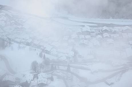 Winter in the small village of Caprile and the Cordevole river 