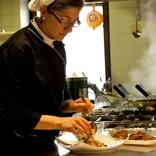 Chef working in the kitchen of Morgenleit restaurant, Sauris