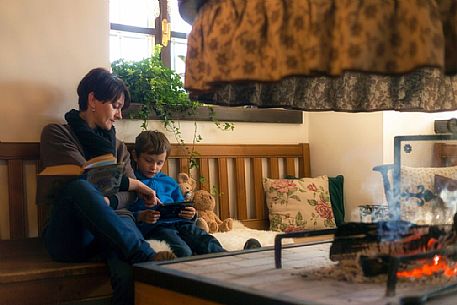 Mother and son in Meuble Pa'Krhaizar, one of the most beautiful and characteristic house of Sauris village, Lateis