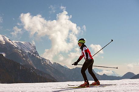 Cross-country skiing on the slopes of Sauris di Sopra , in the background the Monte Bivera , Sauris