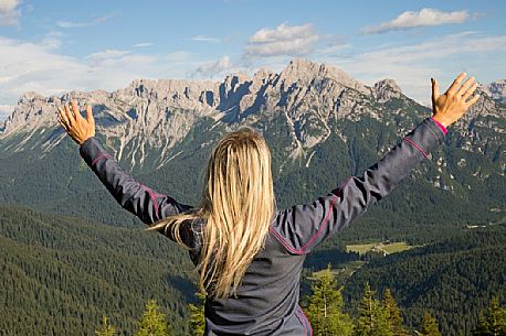 Hiker looks at the landscape from Val Visdende, Comelico, Italy