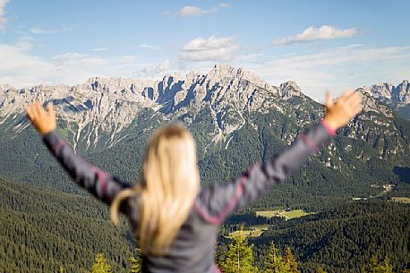 Hiker looks at the landscape from Val Visdende, Comelico, Italy