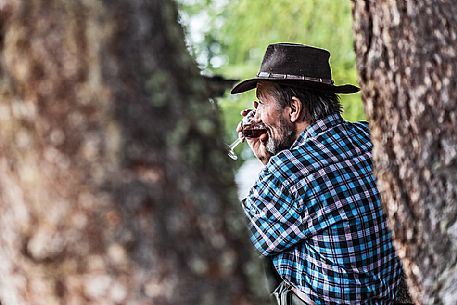 Old man drinking red wine, South Tyrol, Dolomites, Italy 