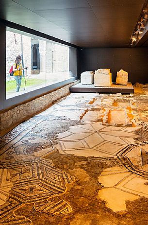 tourist to South Halle admire the ancient remains of the mosaics of Aquileia basilica, Italy