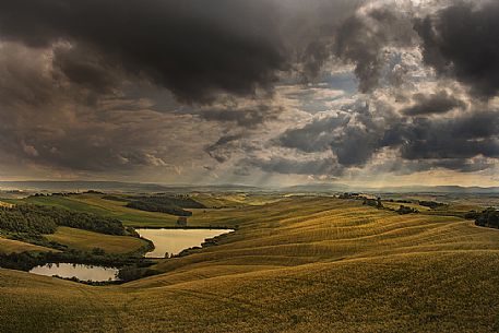 Light over the lake in the Crete Senesi landscape, Tuscany, Italy