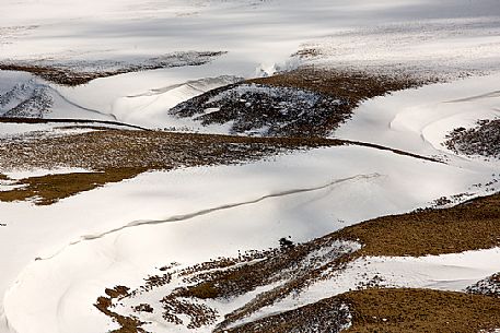 Pattern on the snow along the bank of the Fosso dei Mergani, Pian Grande di Castelluccio di Norcia, Sibillini National park, Umbria, Italy, Europe