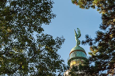 Vision among the trees, lighthouse of Victory, or Faro della Vittoria, National Monument in  Trieste, Friuli Venezia Giulia, Italy, Europe