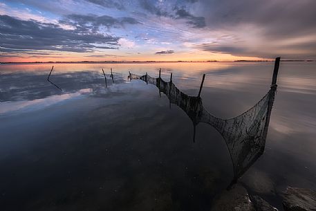 Fish nets in the Grado lagoon at sunset, Friuli Venezia Giulia, Italy