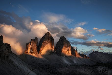 Tre cime di Lavaredo peak painted by sunlight, dolomites, South Tyrol, Italy