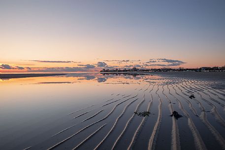 Shoreline reflections in Grado Island at sunset, Friuli Venezia Giulia, Italy